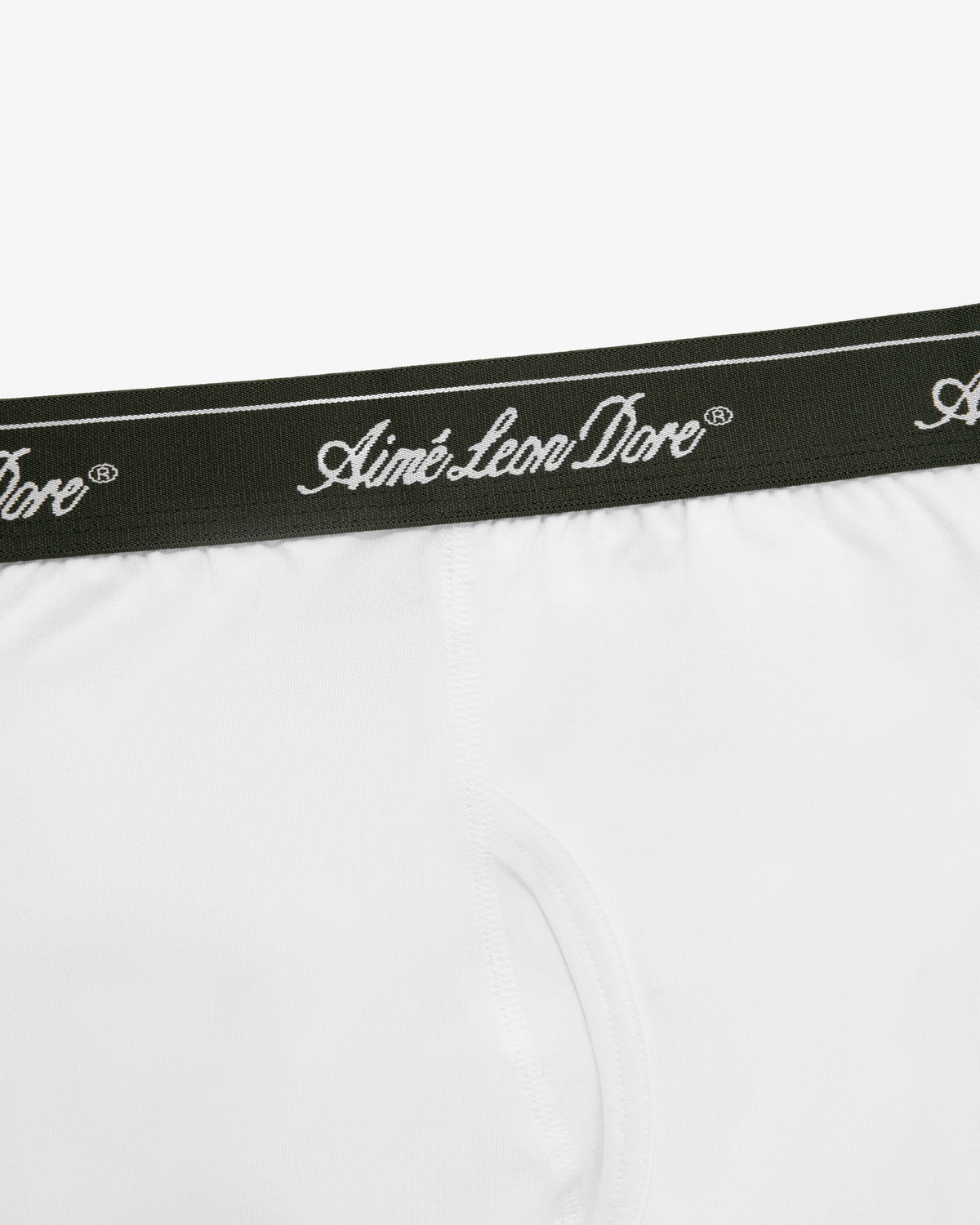 Close-up of white Boxer Brief 3-Pack underwear with a dark waistband featuring Aimé Leon Dore in white script.