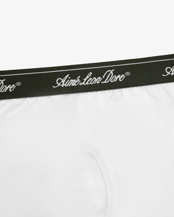 Close-up of white Boxer Brief 3-Pack underwear with a dark waistband featuring Aimé Leon Dore in white script.