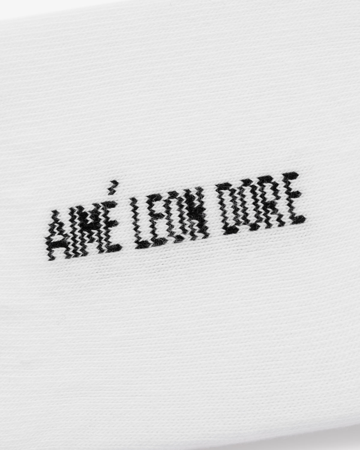 Black wavy Aimé Leon Dore text embroidered on white No-Show Sock 3-Pack.