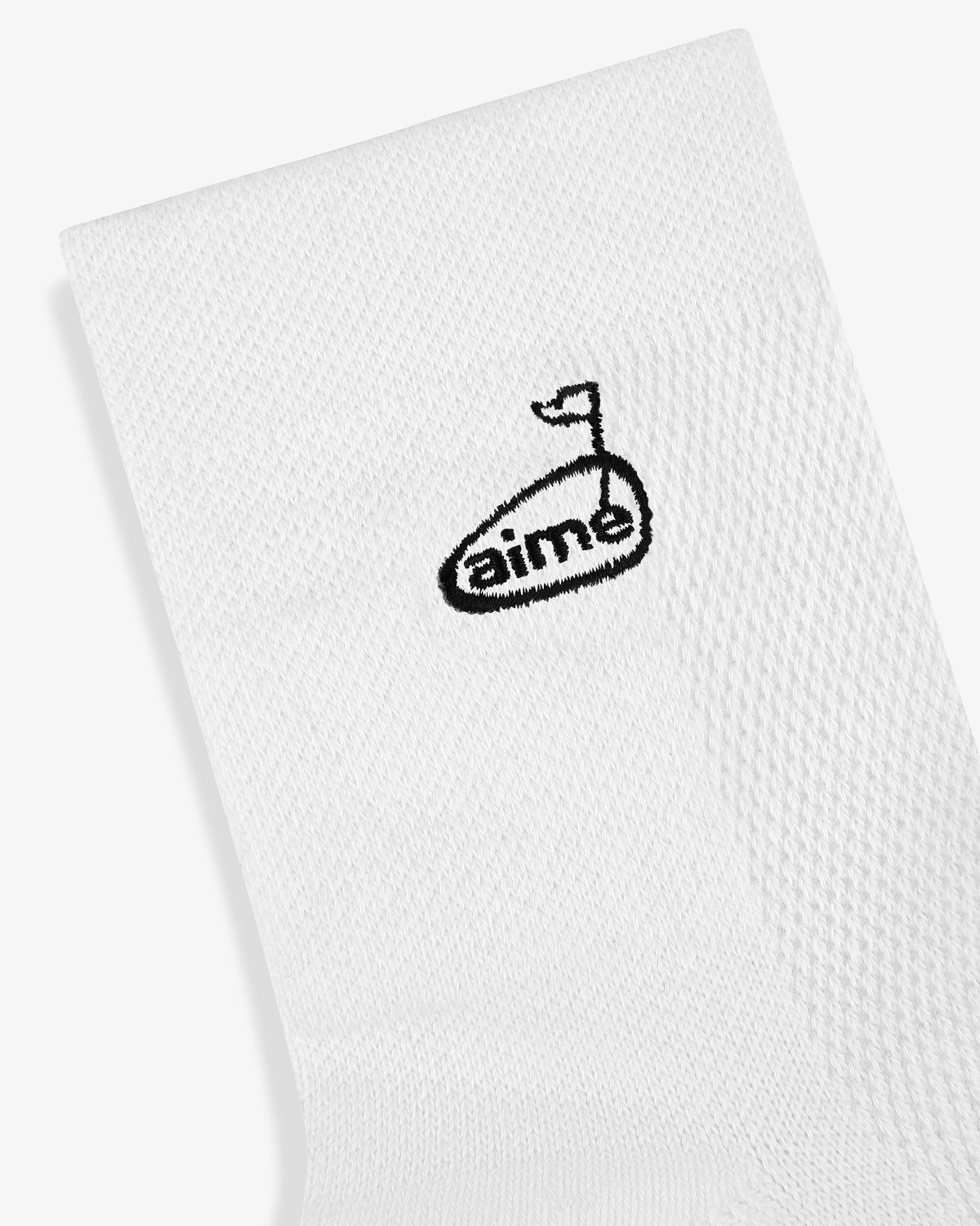 The ALD Golf Performance Ankle Sock features a small black golf club and flag logo and "aime" embroidered near the top.