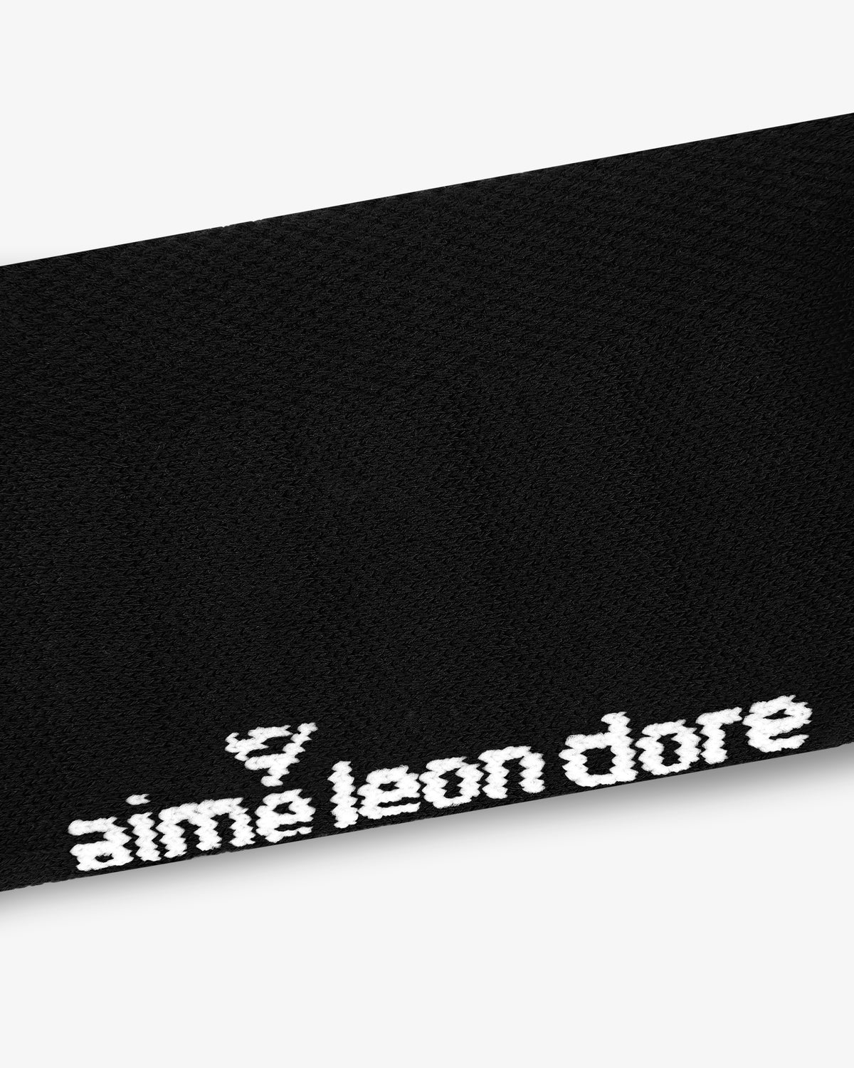 Black fabric ALD Golf Performance Ankle Sock with white "aime leon dore" text and a small triangle logo above it.