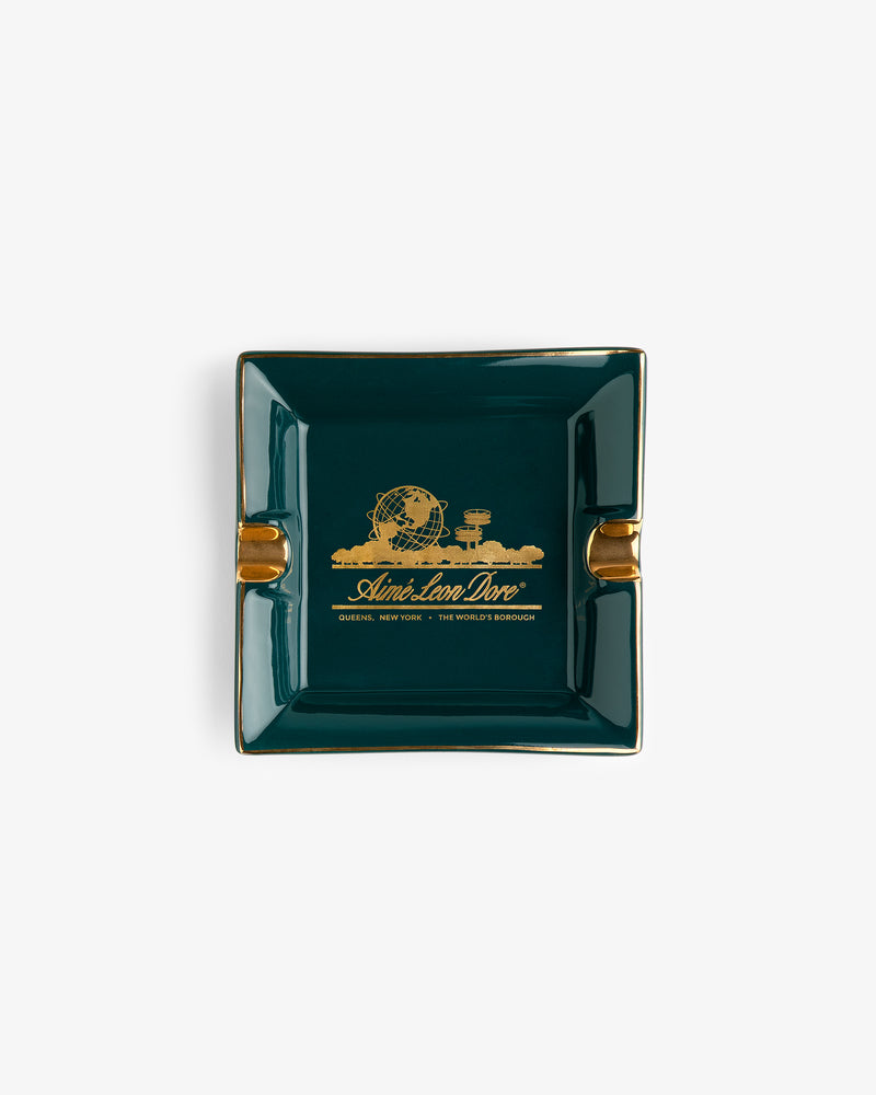 Unisphere Ashtray: square, green with gold trim, World’s Fair design, labeled “And we love love, Queens, New York.”.