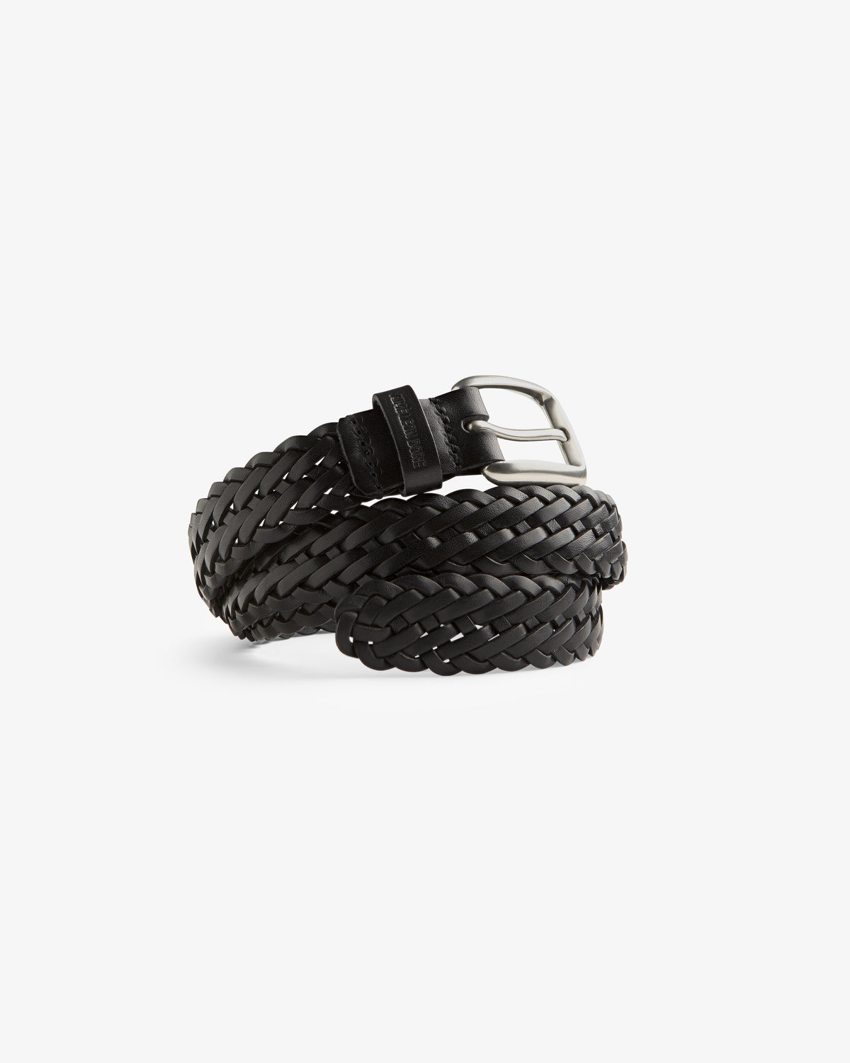 The Braided Leather Belt in black leather with a silver buckle, coiled on a white background.