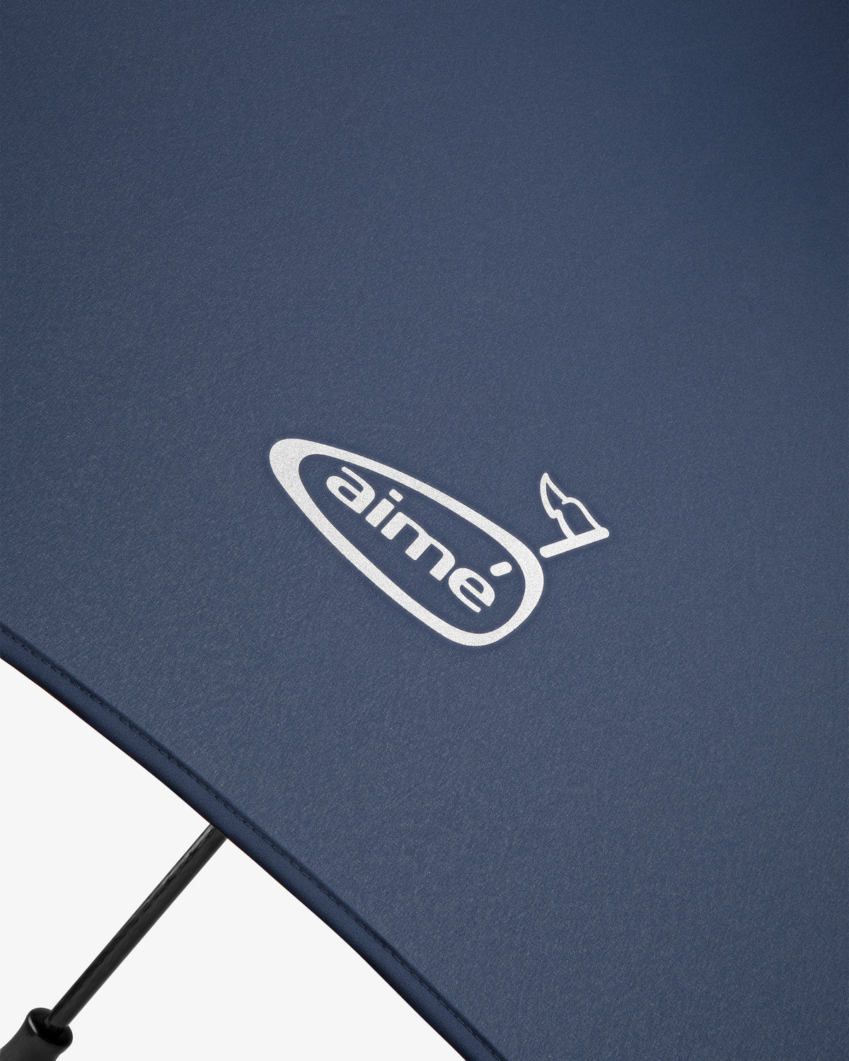Close-up of the ALD Golf Spectator Umbrella in blue, featuring a white aimé logo and a small bird design.