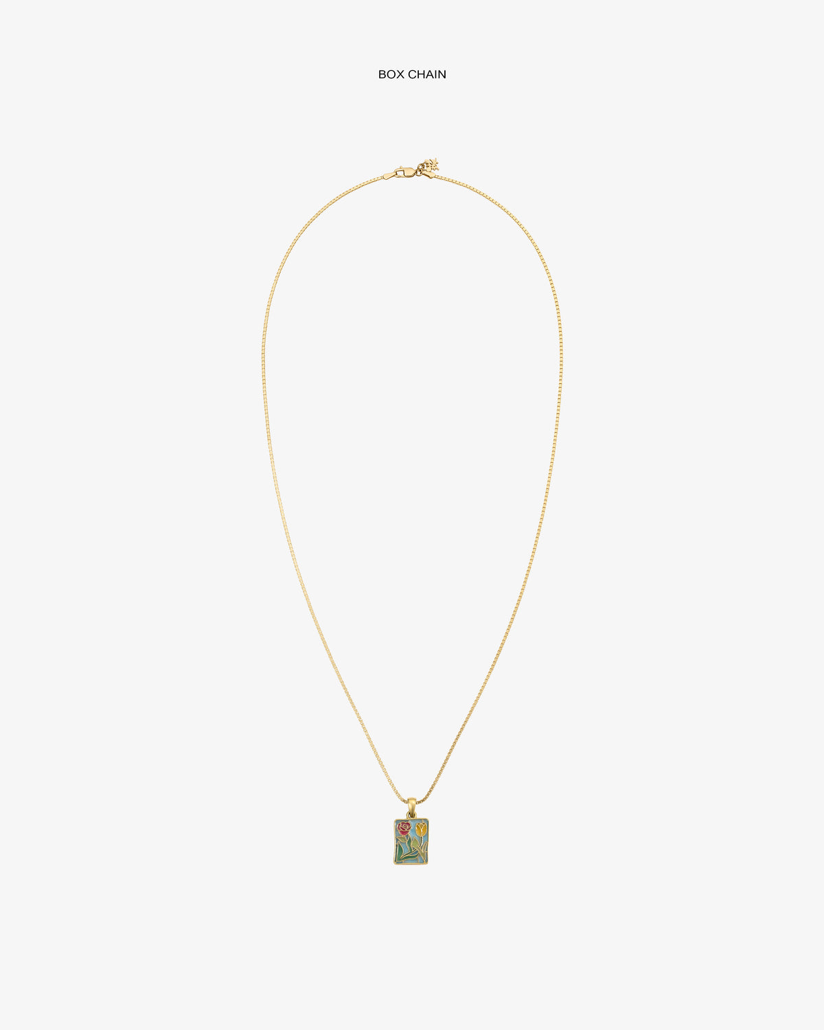 14Kt Gold Stained Glass Crest Pendant on a box chain features a colorful floral design with a red heart.