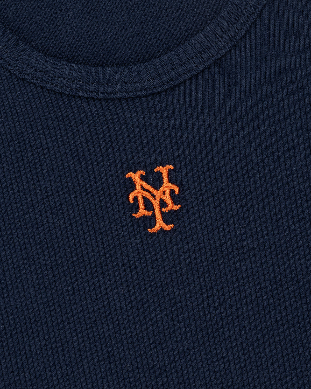 Close-up of a Mets Tank Top: navy blue ribbed fabric with an orange NY logo embroidered on the chest.