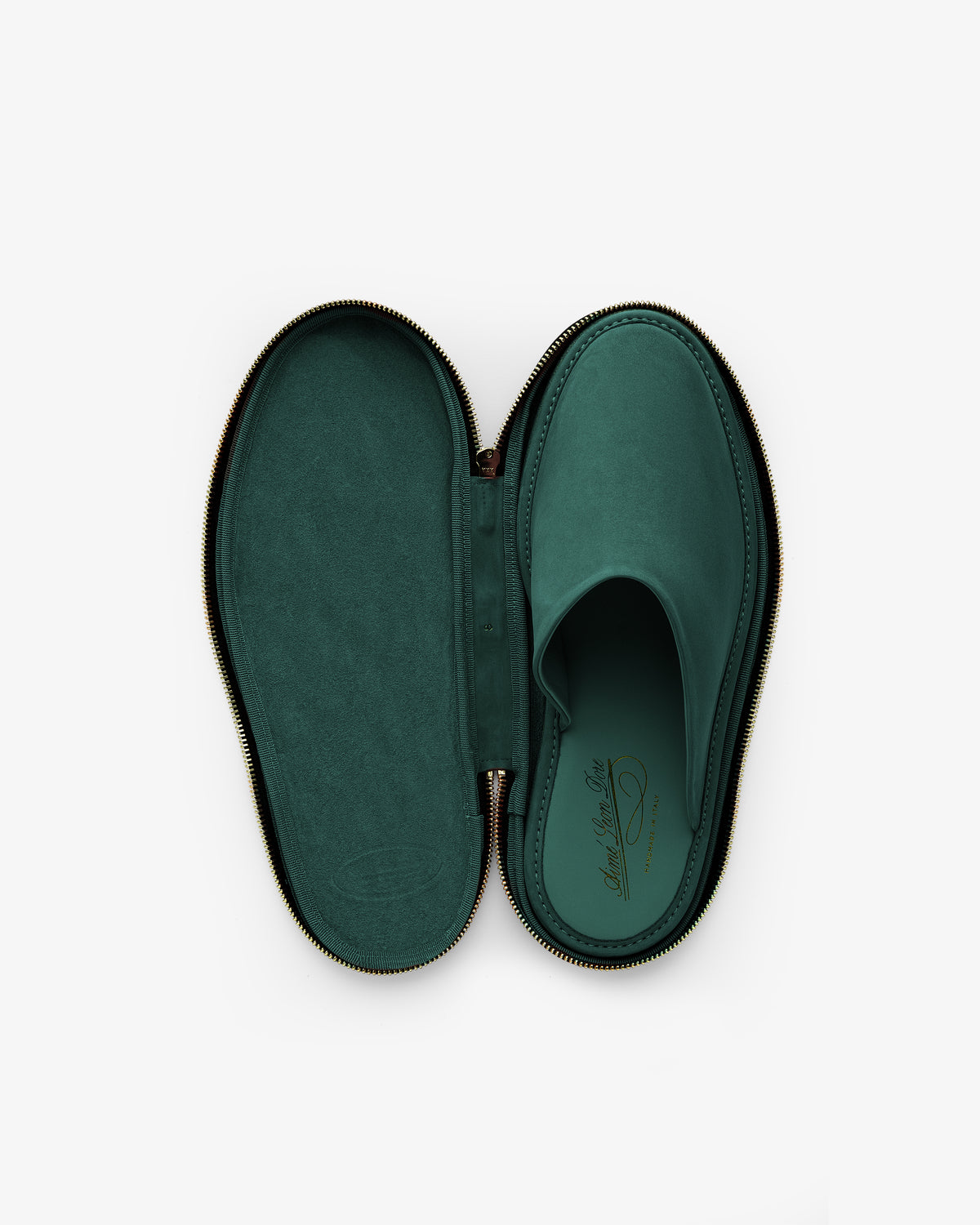 A Nubuck Travel Slipper in green sits inside a matching oval zippered case on a white background.
