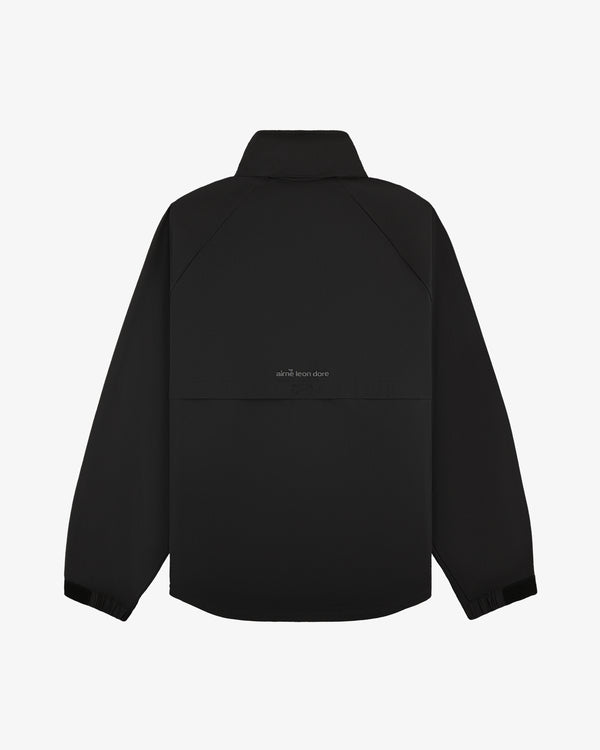 Black ALD Golf Cordura Tips Jacket with collar, elastic cuffs, and “aimé leon dore” text on the back.