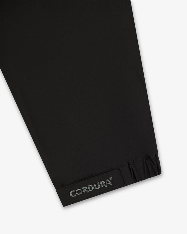ALD Golf Cordura Tips Jacket: black fabric sleeve with CORDURA text near elastic cuff on white background.