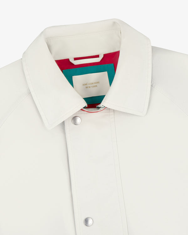 Close-up of the Sailing Jacket’s white collar with silver snaps and vibrant inner labels.