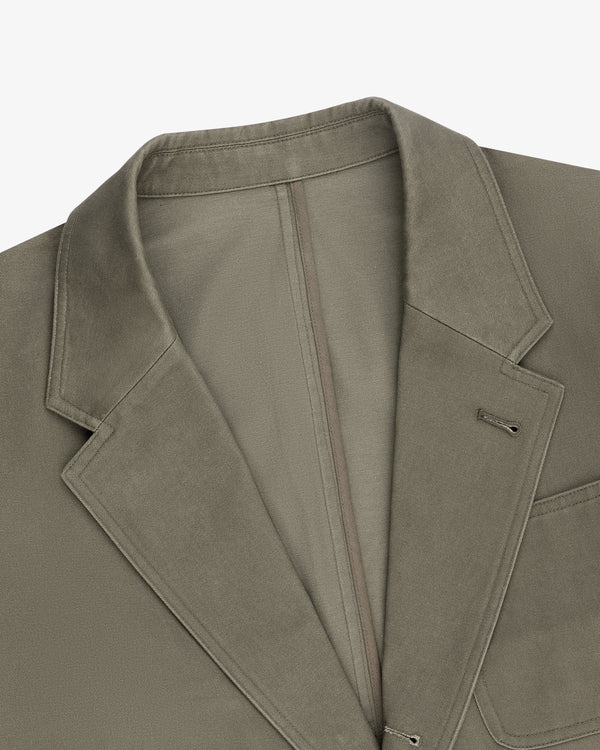 Close-up of a Single-Breasted Washed Twill Suit Jacket in olive green with notch lapel and chest pocket on white.