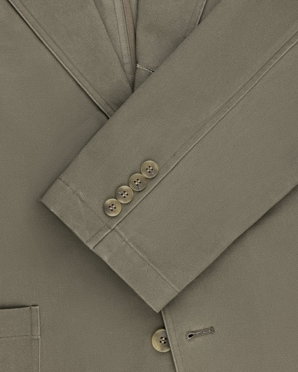 Close-up of Single-Breasted Washed Twill Suit Jacket sleeve with four brown buttons and visible stitching.