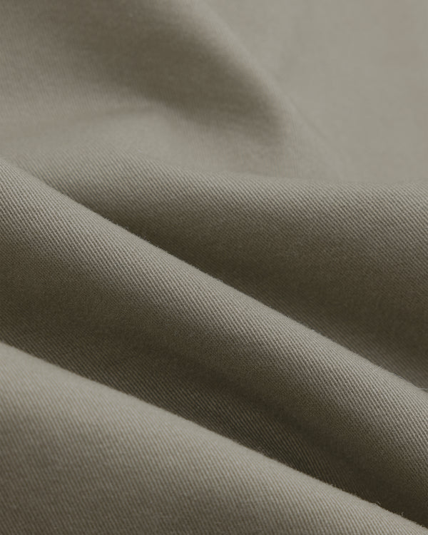 Close-up of Single-Breasted Washed Twill Suit Jacket’s gray fabric, showing weave texture, soft folds, and subtle highlights.