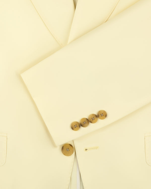 Close-up of Single-Breasted Peak Lapel Suit Jacket in cream, showing four cuff buttons and partial front pockets.