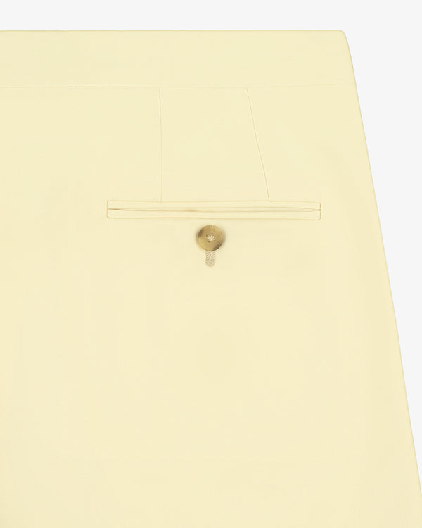 Close-up of Gabardine Suit Trouser in cream, featuring a single back pocket with beige button and light stitching.