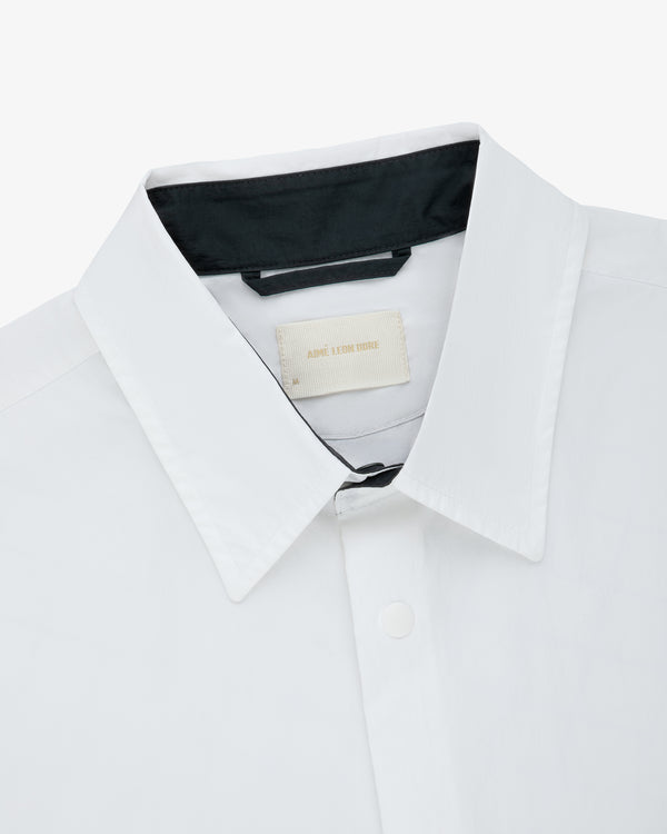 Colorblock Sport Shirt with black inner collar and beige tag, top-view on a white background.