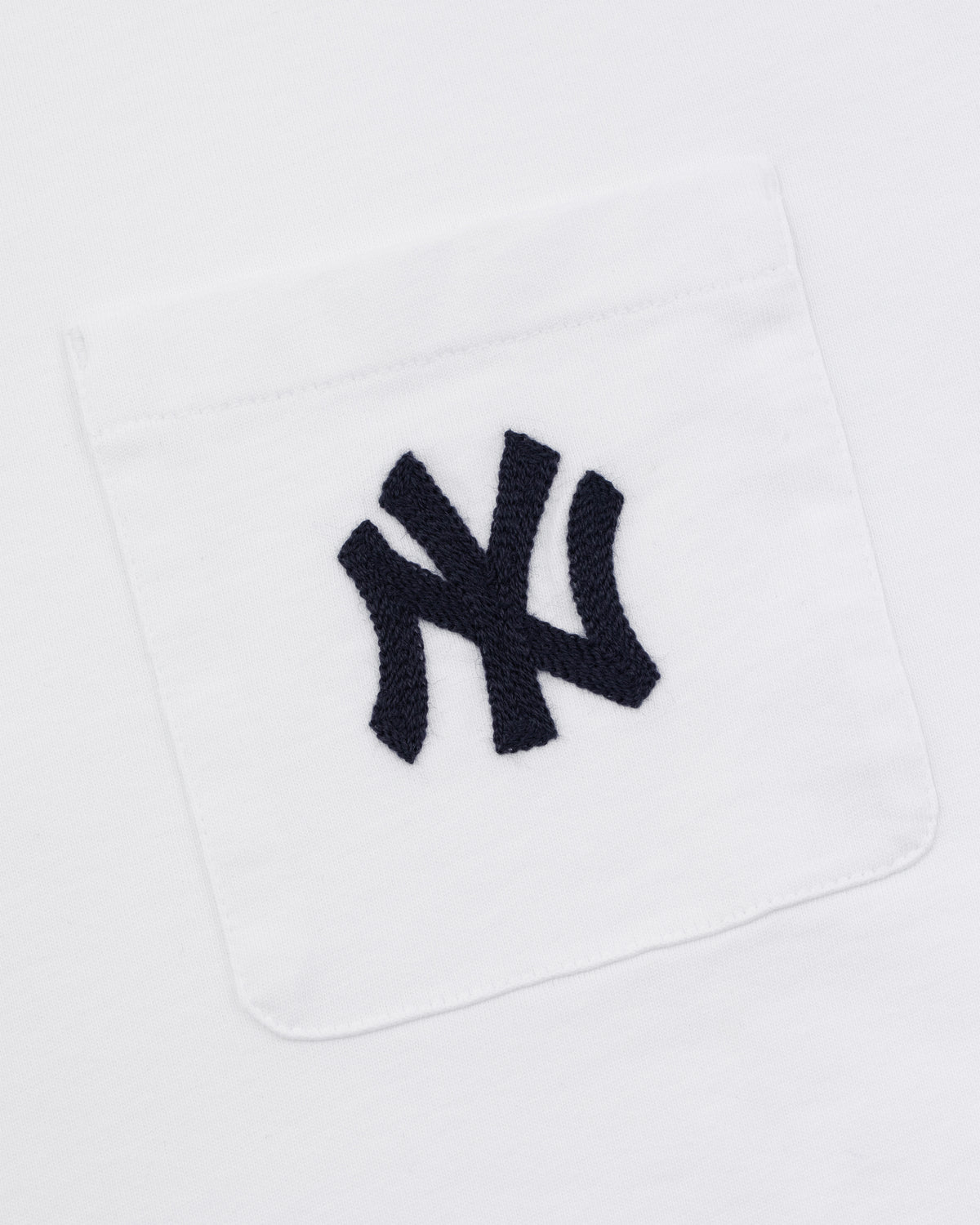 Yankees Chainstitch Pocket Tee featuring a white fabric pocket with an embroidered dark blue interlocking NY logo.