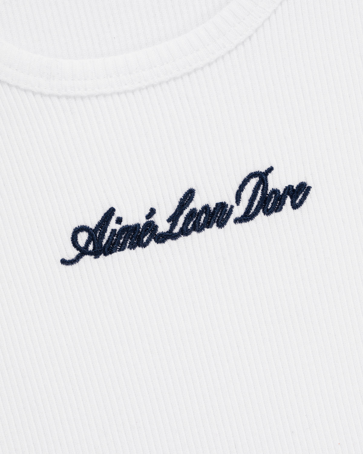 White ribbed Embroidered Logo Tank Top with navy blue Aimé Leon Dore cursive text near the collar.