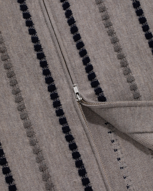 Closeup of the Jacquard Stripe Polo Cardigan in gray with textured vertical stripes and a partially unzipped zipper.