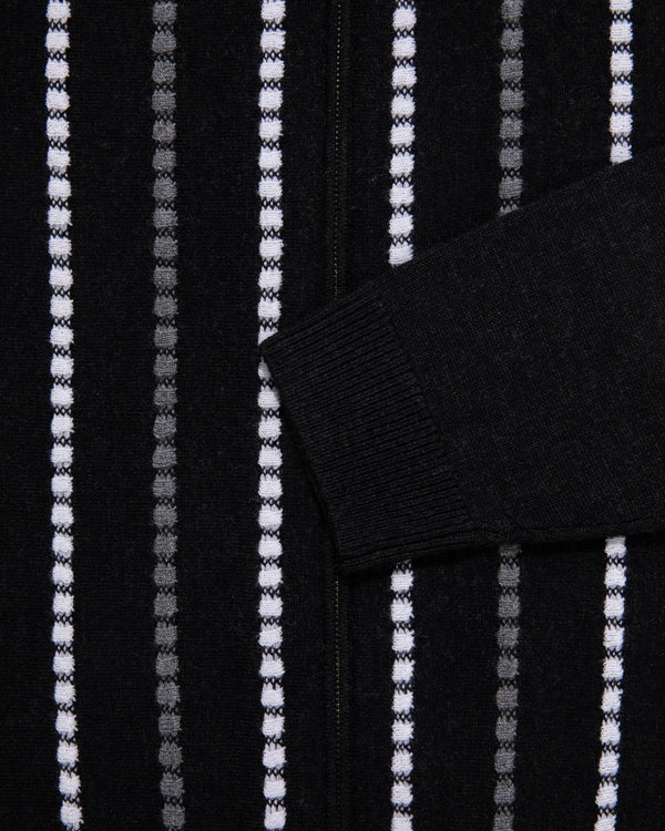 Black jacquard stripe polo cardigan with vertical white/gray dots and ribbed black sleeve cuff.