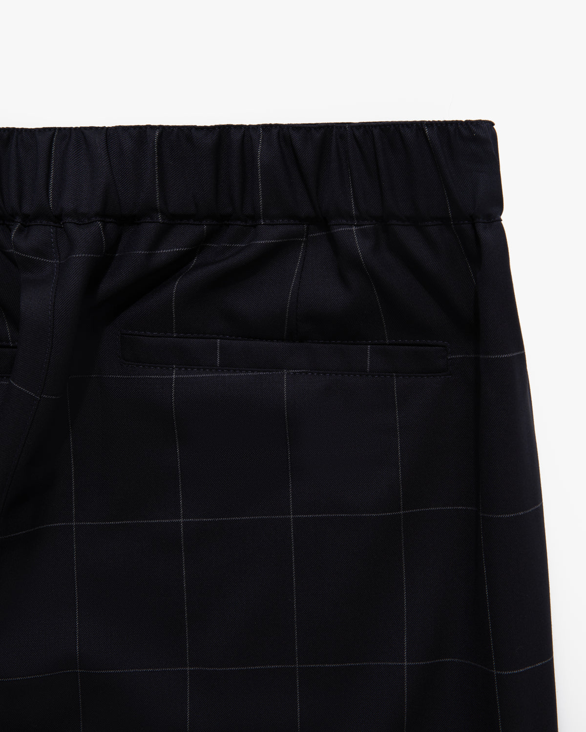 Close-up of Windowpane Elasticated Waist Suit Trouser in black with white pattern and back welt pocket.