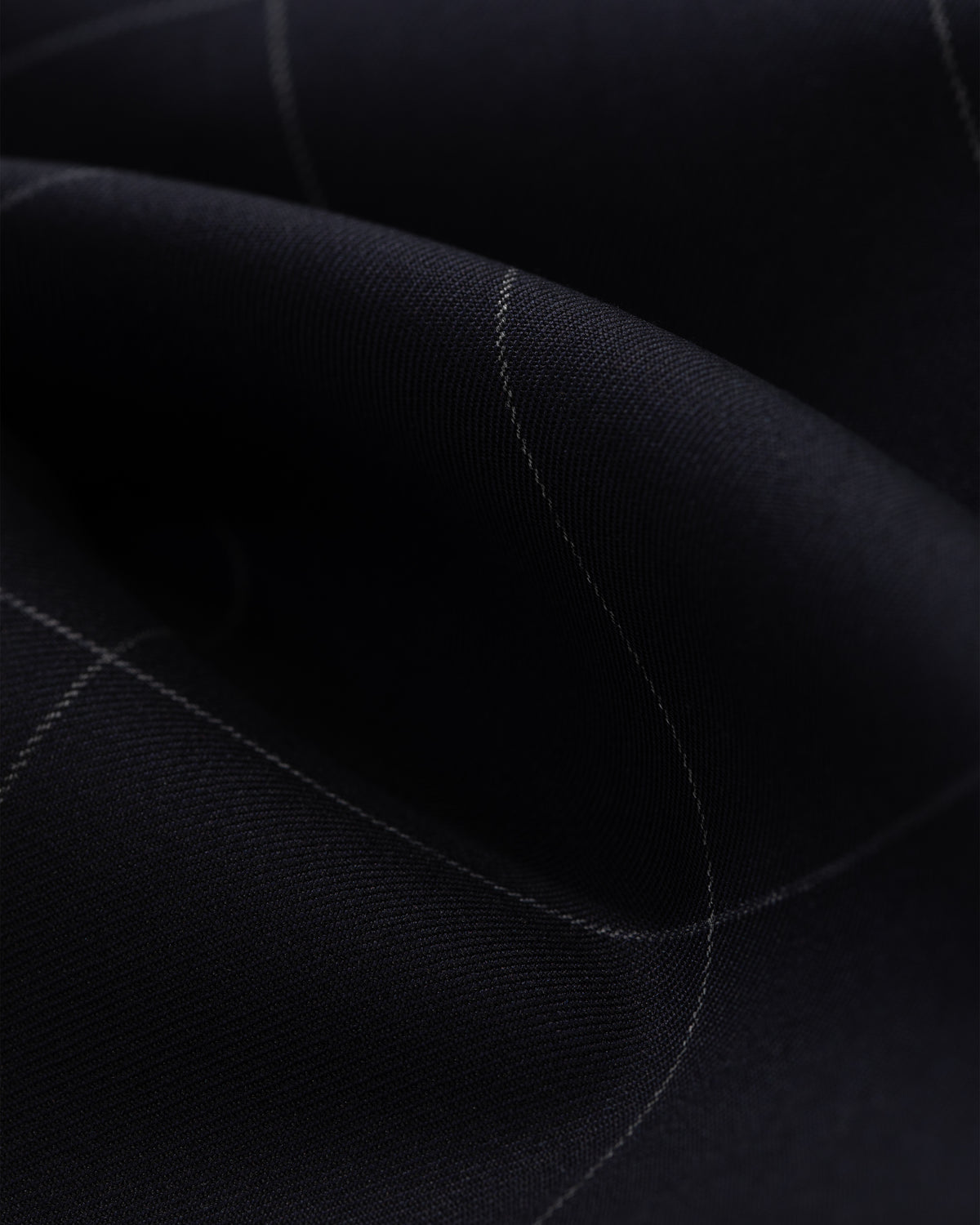 Close-up of Windowpane Elasticated Waist Suit Trouser, dark fabric with white grid lines and visible texture.