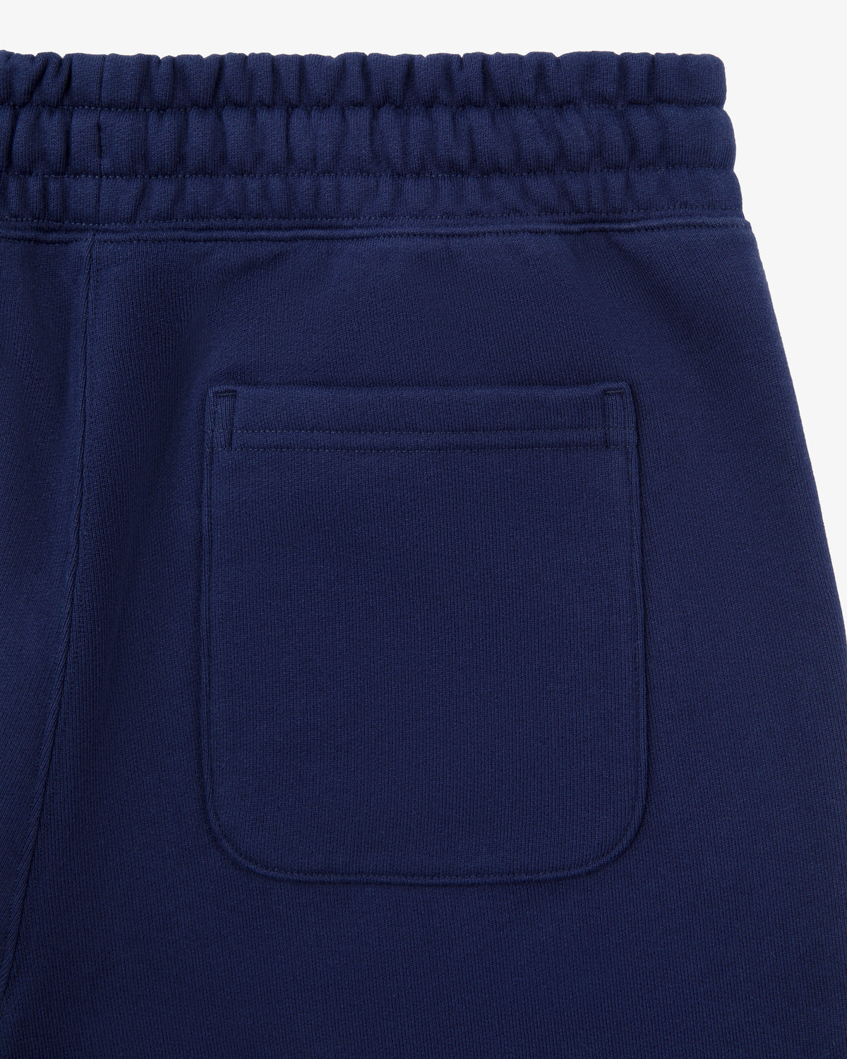 Close-up of the Tonal Logo Sweatpants' navy pocket and elastic waistband, shown on a white background.