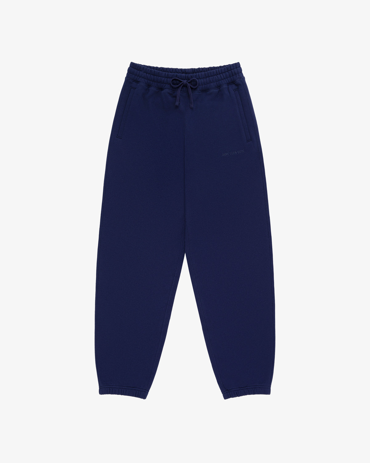 Tonal Logo Sweatpants in navy blue with elastic waistband, drawstring, side pockets, and elastic cuffs, laid flat.