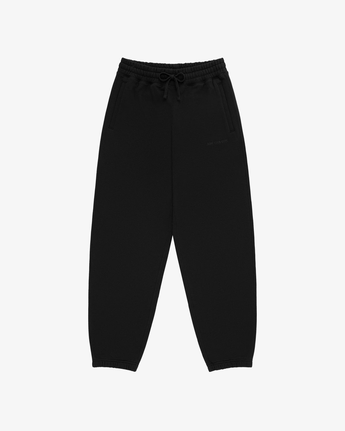Tonal Logo Sweatpants in black with drawstring, elastic waistband, and cuffs, laid flat on white background.