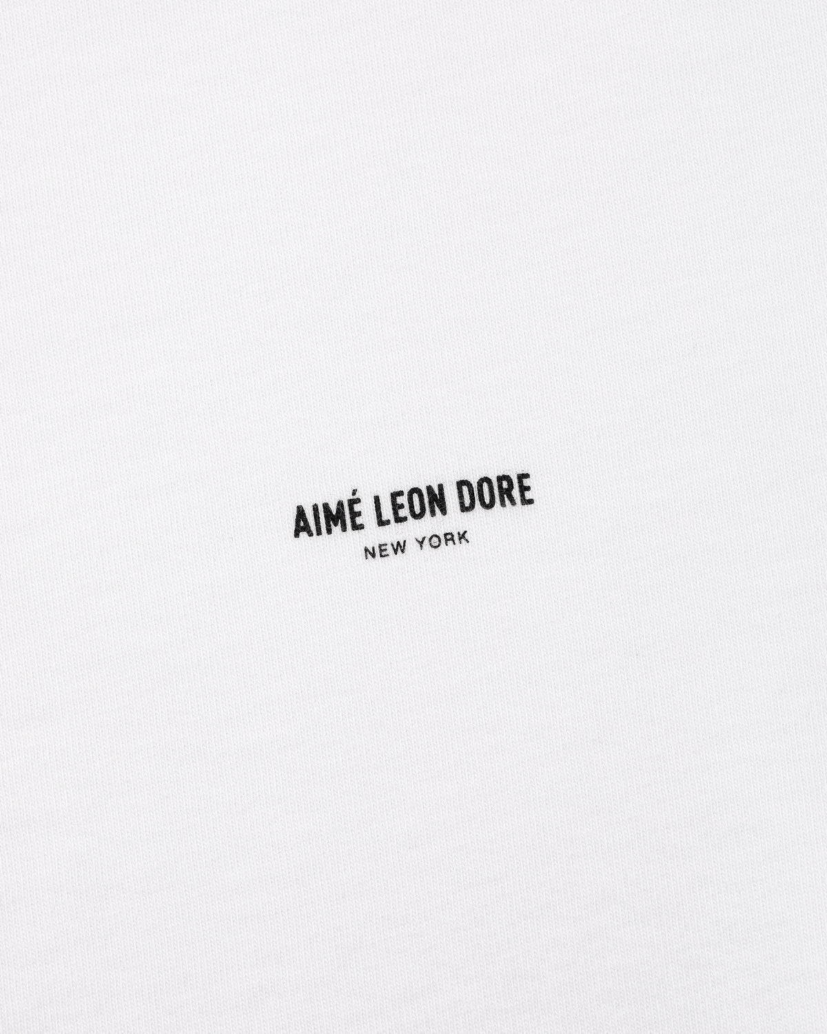 White Micro Logo Tee with small black AIMÉ LEON DORE NEW YORK text centered on the front.