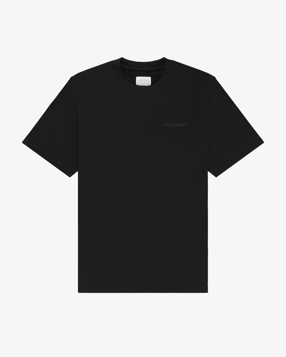 Tonal Logo Tee—black short-sleeve shirt with a small white logo on the left chest, shown on a white background.