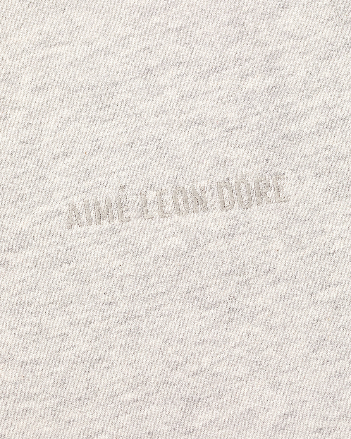 Light heather gray Tonal Logo Tee featuring subtle, raised AIME LEON DORE text embossed at the center.