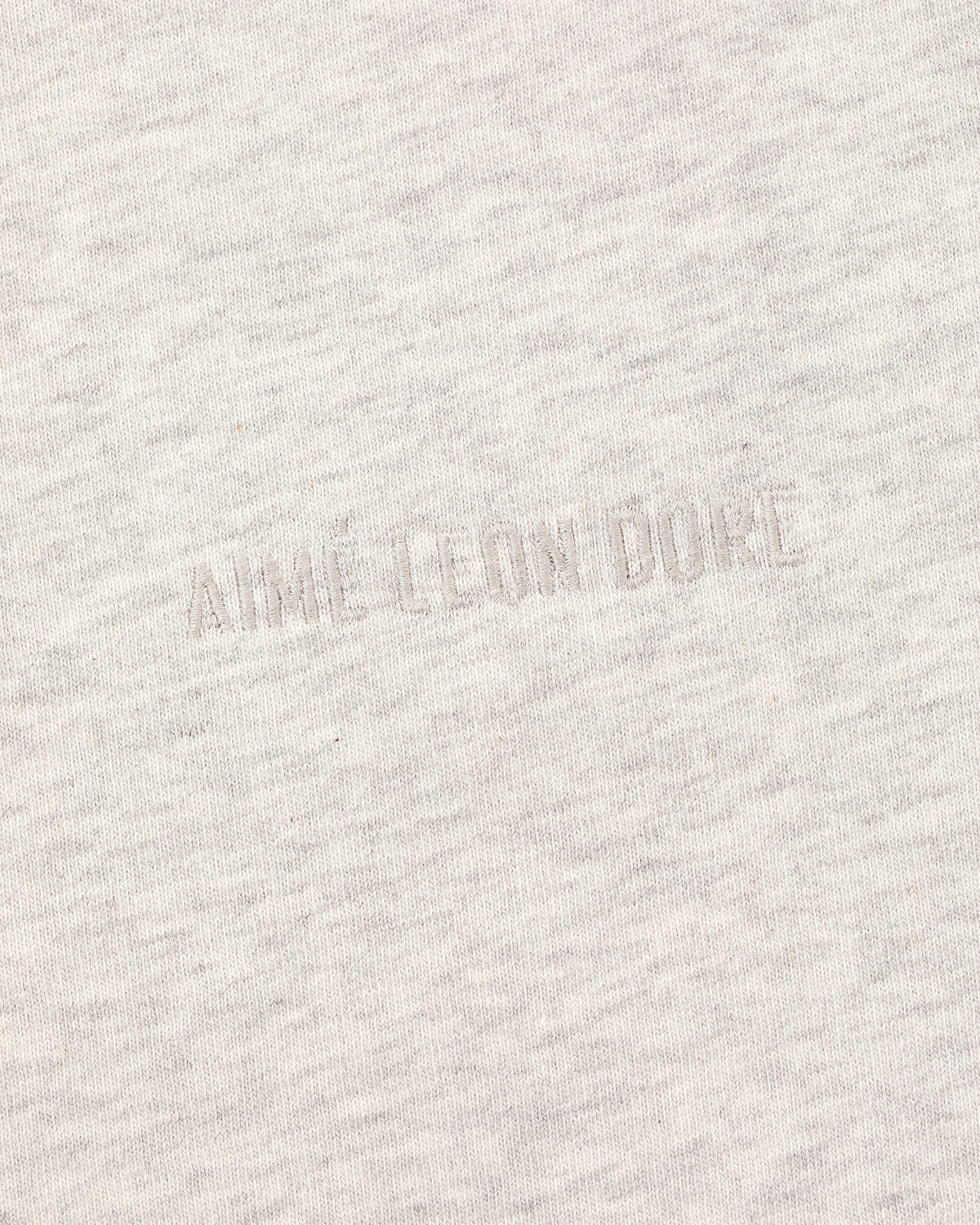 Light grey Long-Sleeve Tonal Logo Tee with faint embossed AIMÉ LEON DORE text.