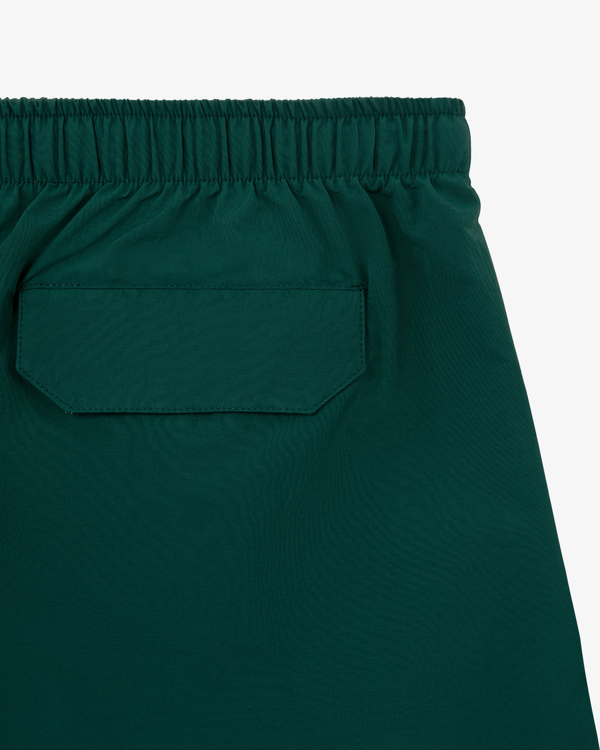 Close-up of the green elastic waistband with flap pocket on Core Nylon Short.