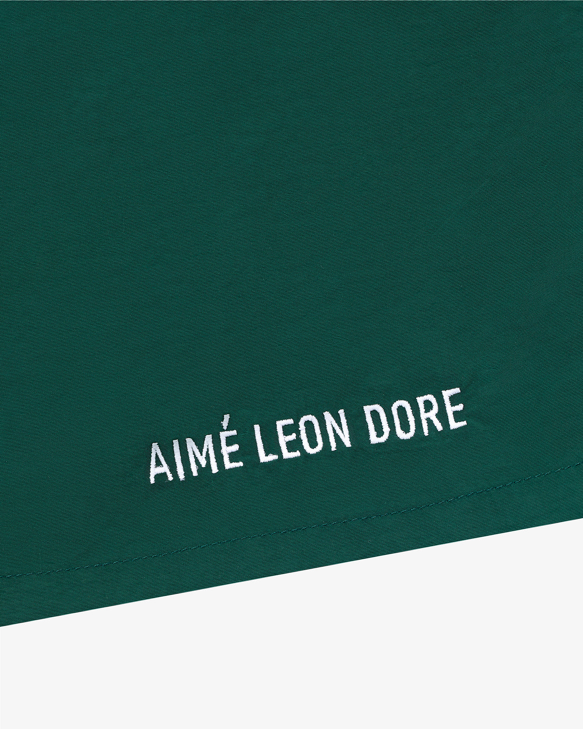 Green Core Nylon Short with AIMÉ LEON DORE embroidered in white near the hem.