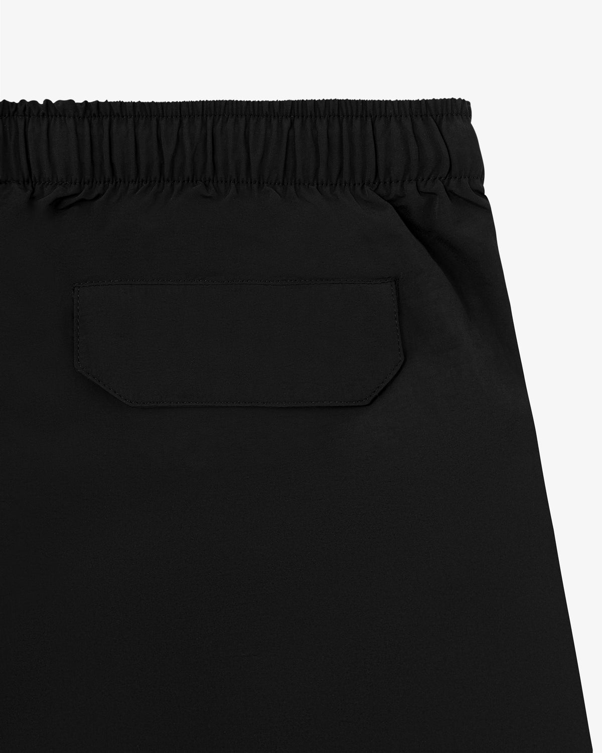 Close-up of the back of black Core Nylon Short with an elastic waistband and a single flap back pocket.