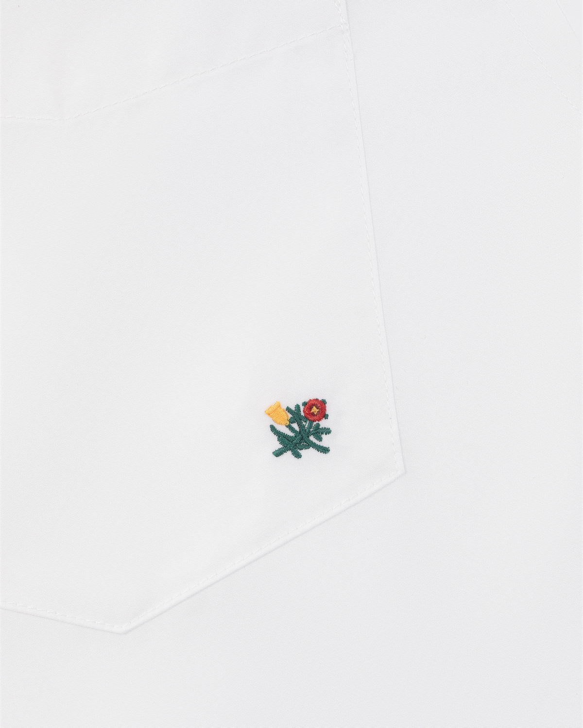 Crest Oxford Shirt with pocket featuring a small embroidered green cactus, red flower, and yellow detail at corner.