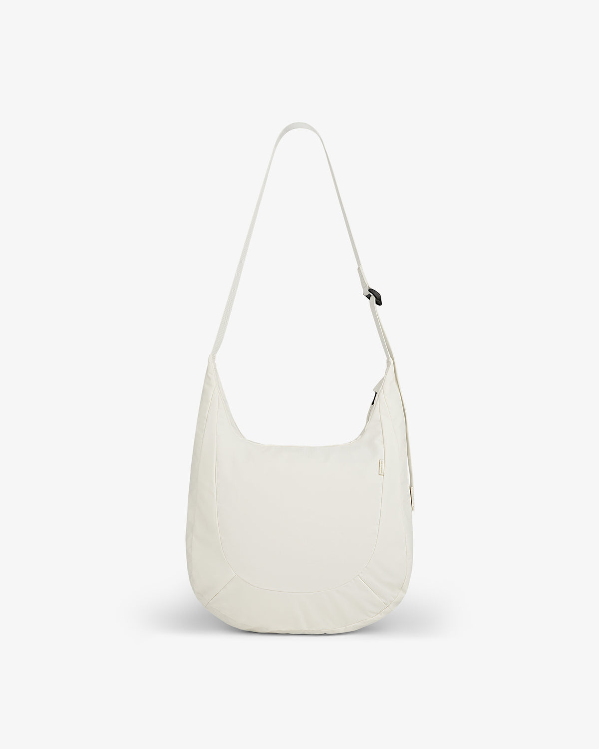 A minimalist white Nylon Messenger Bag with a long strap, displayed against a plain white background.