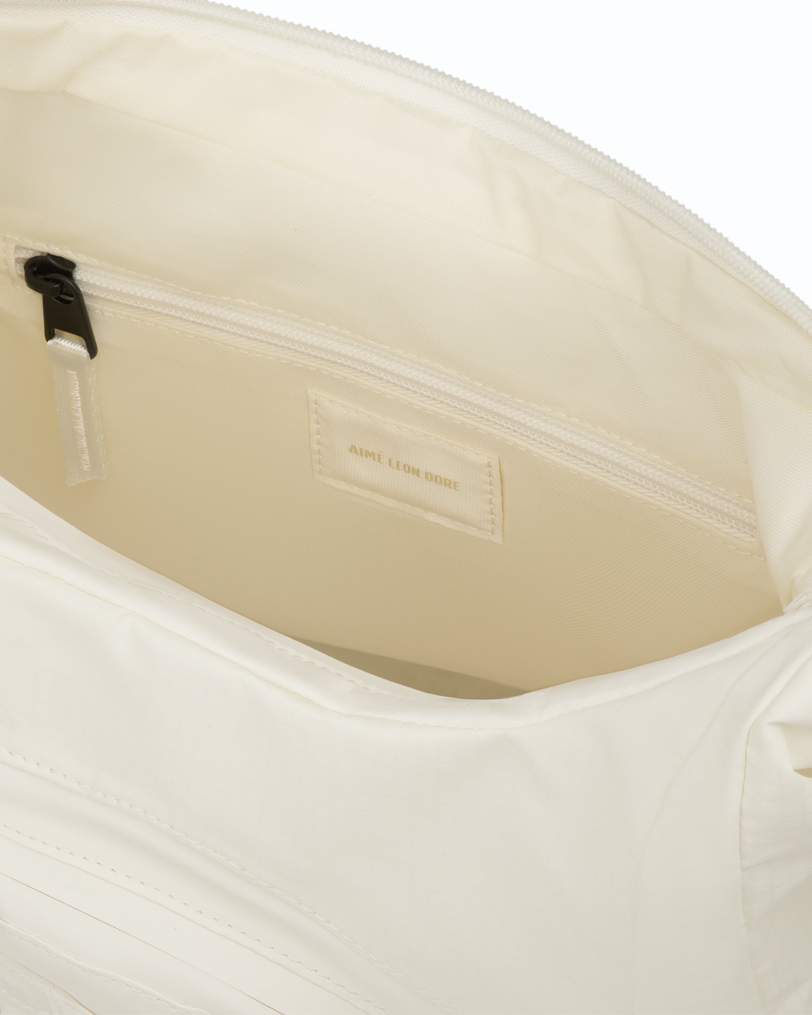 Close-up of the Nylon Messenger Bag’s interior, showing a zip pocket and an Aime Leon Dore label.