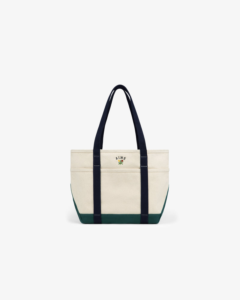 Small Crest Contrast Tote Bag with black handles, green base, and small front embroidery, on a white background.
