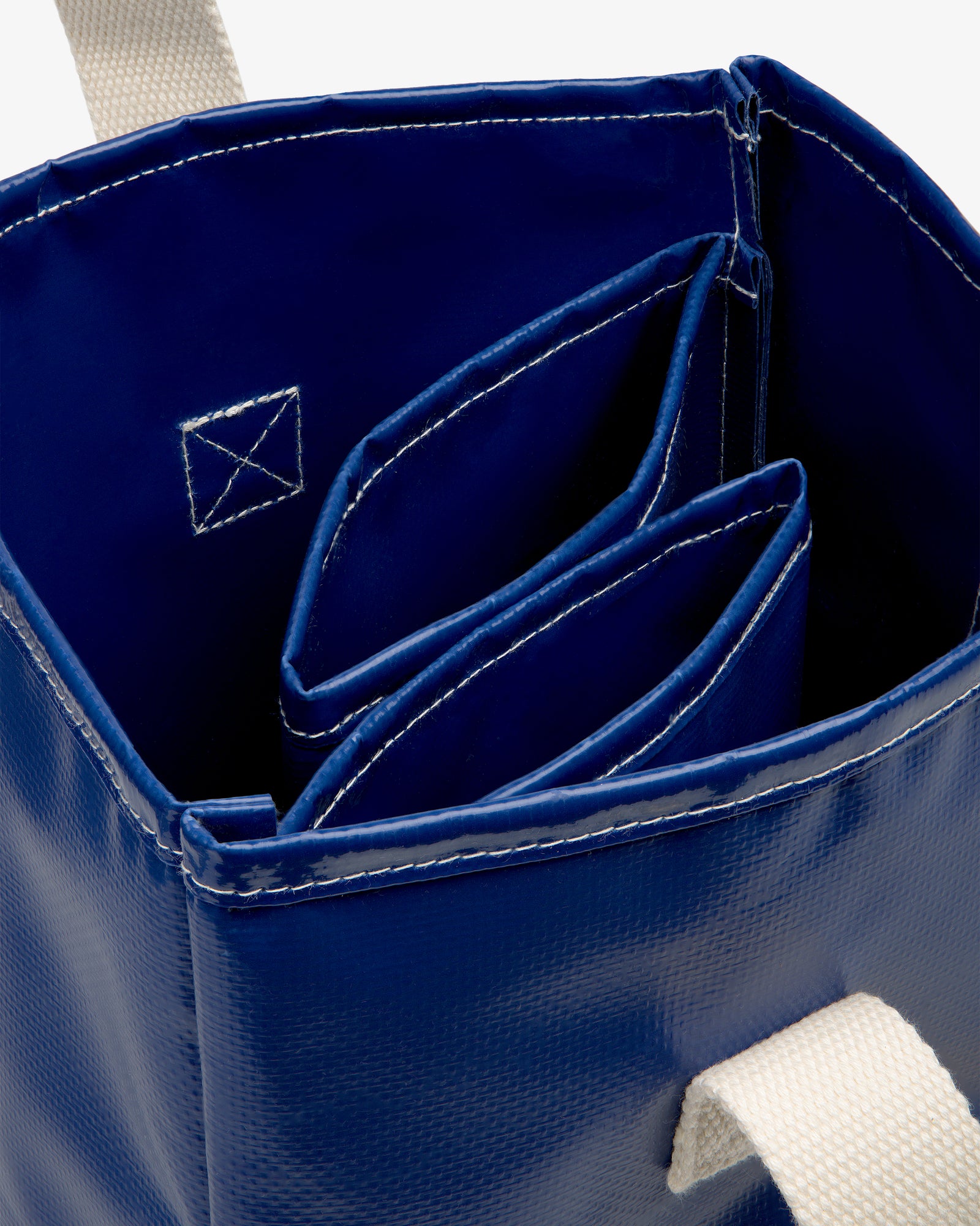 Top view of the Marina Bottle Tote in blue with white handles and two interior pockets.