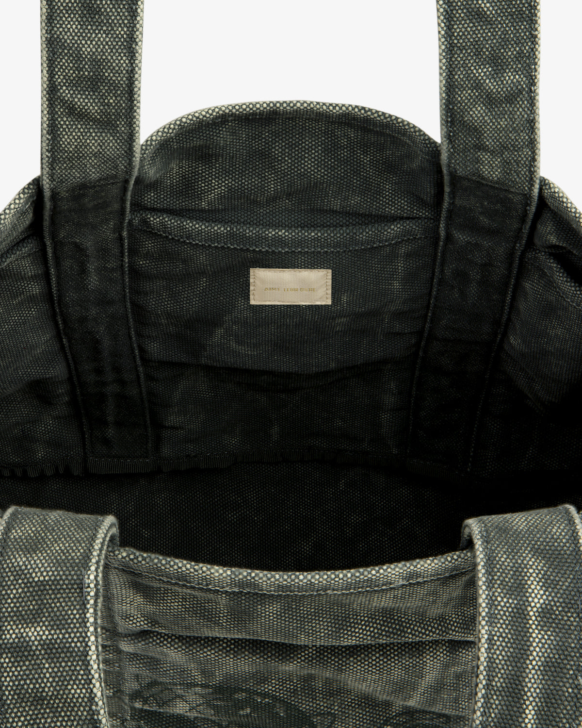 Top view of the Sun Faded Large Unisphere Tote Bag, gray and textured, with interior label near the top seam.