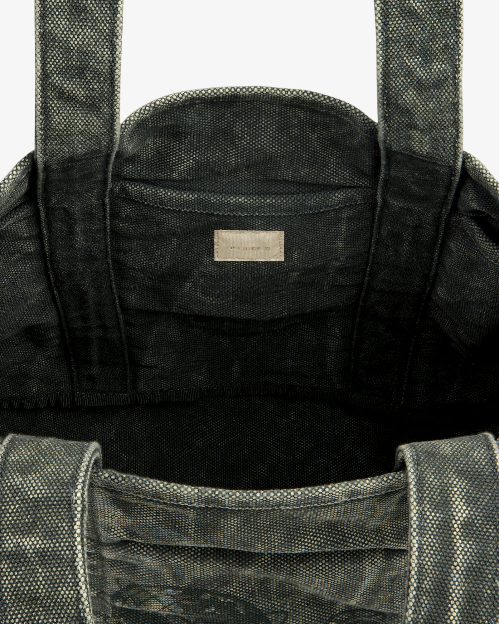 Top view of the Sun Faded Large Unisphere Tote Bag, gray and textured, with interior label near the top seam.