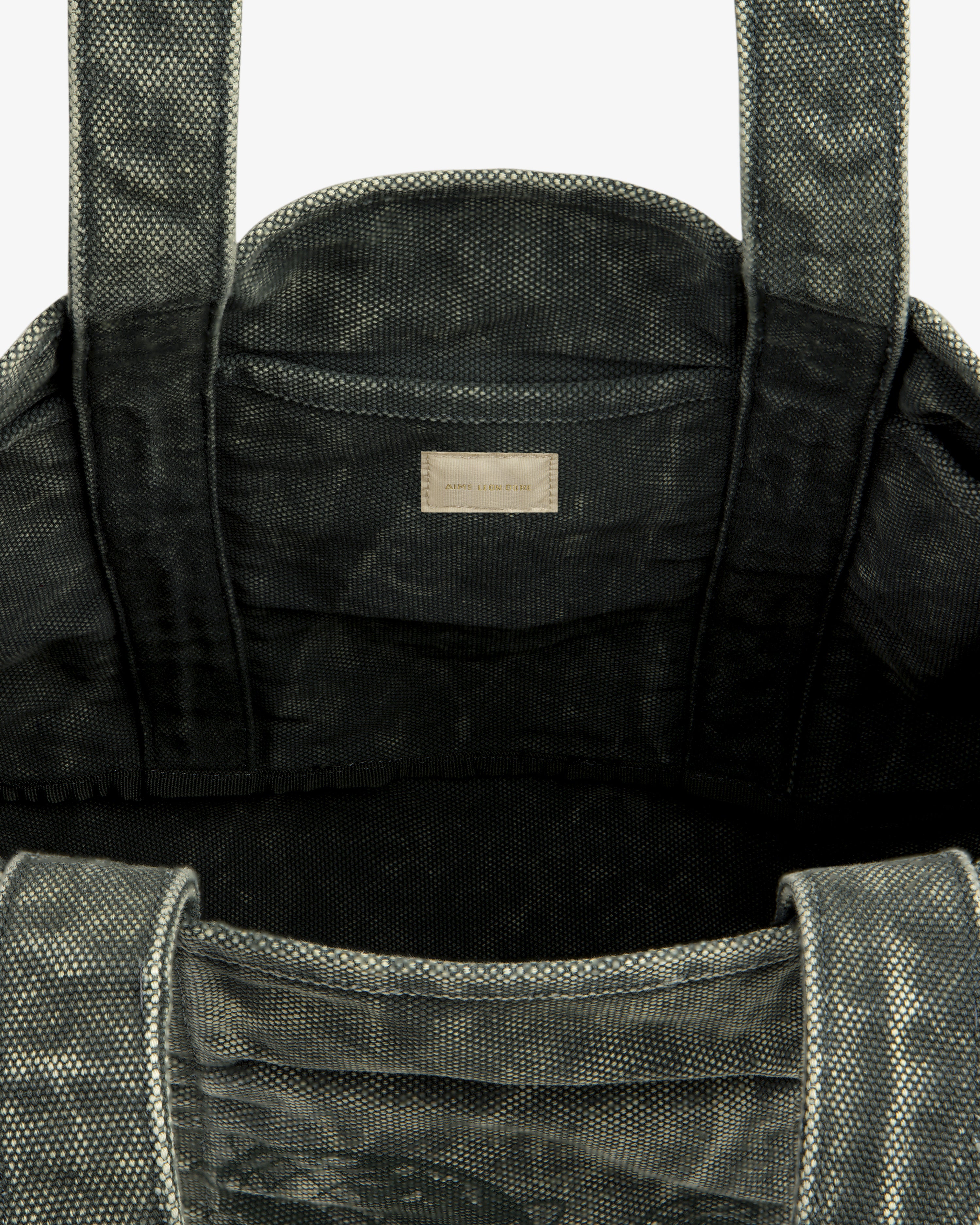 Top view of the Sun Faded Large Unisphere Tote Bag, gray and textured, with interior label near the top seam.