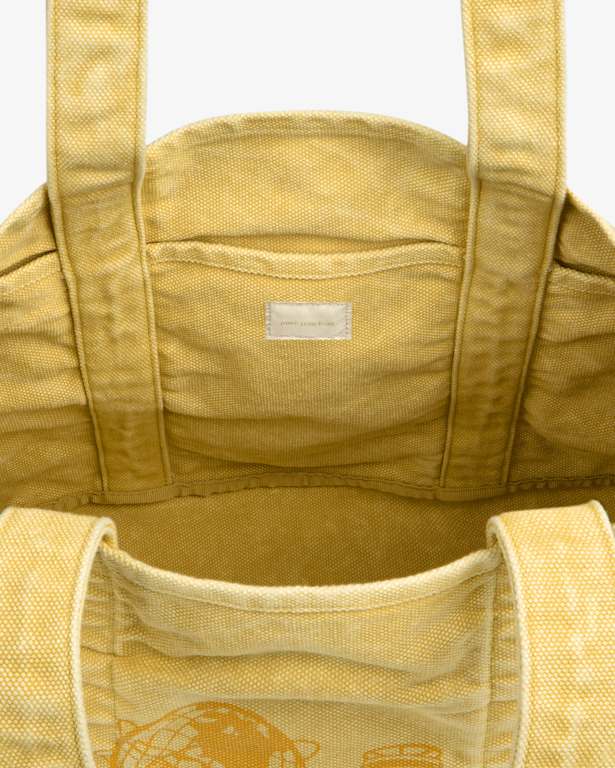 Sun Faded Large Unisphere Tote Bag with handles, top view showing inner label and fabric lining.