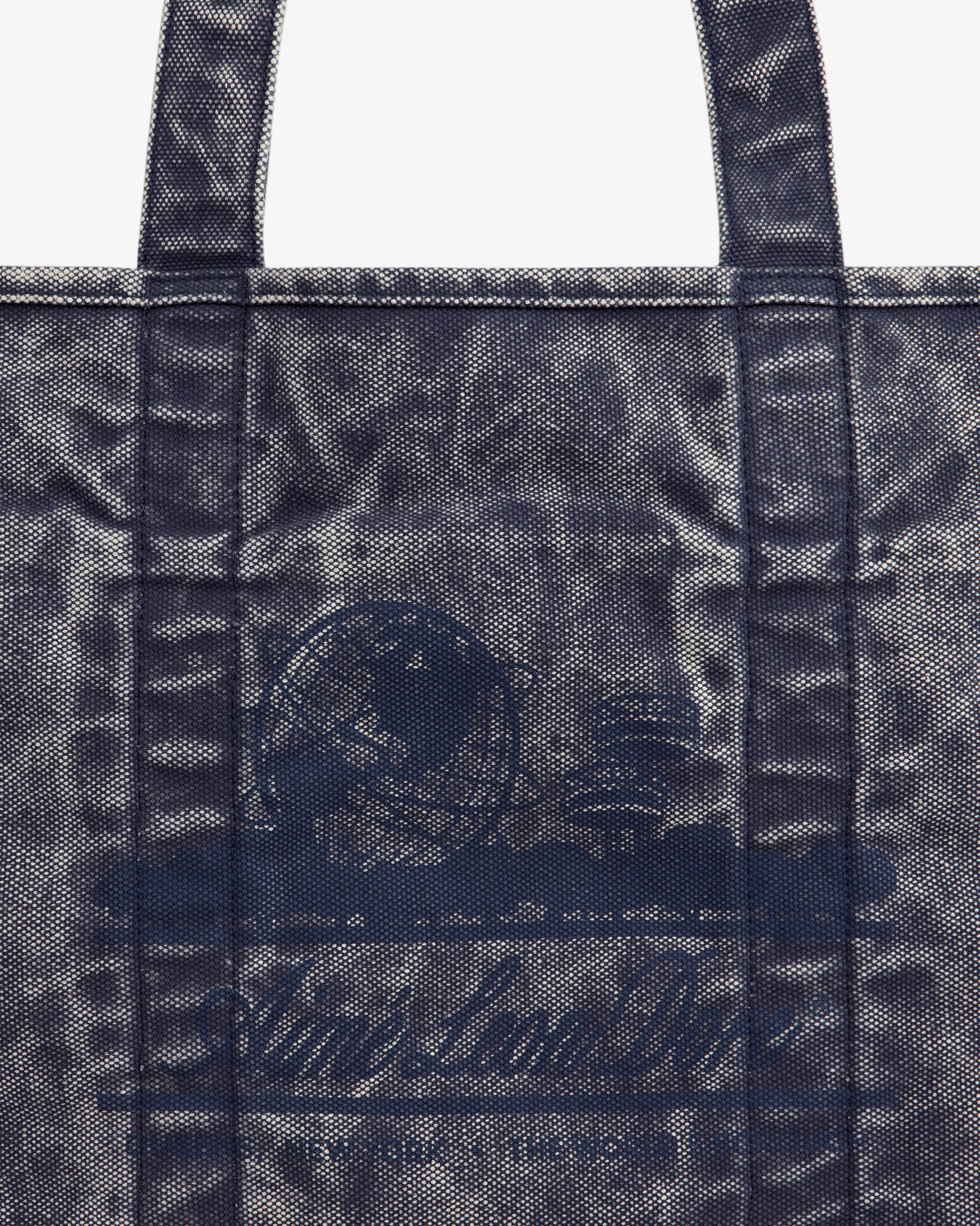 Sun Faded Large Unisphere Tote Bag with blue textured finish, two handles, and faint circular logo on the front.