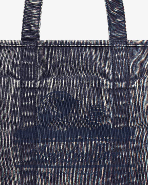 Sun Faded Large Unisphere Tote Bag with blue textured finish, two handles, and faint circular logo on the front.