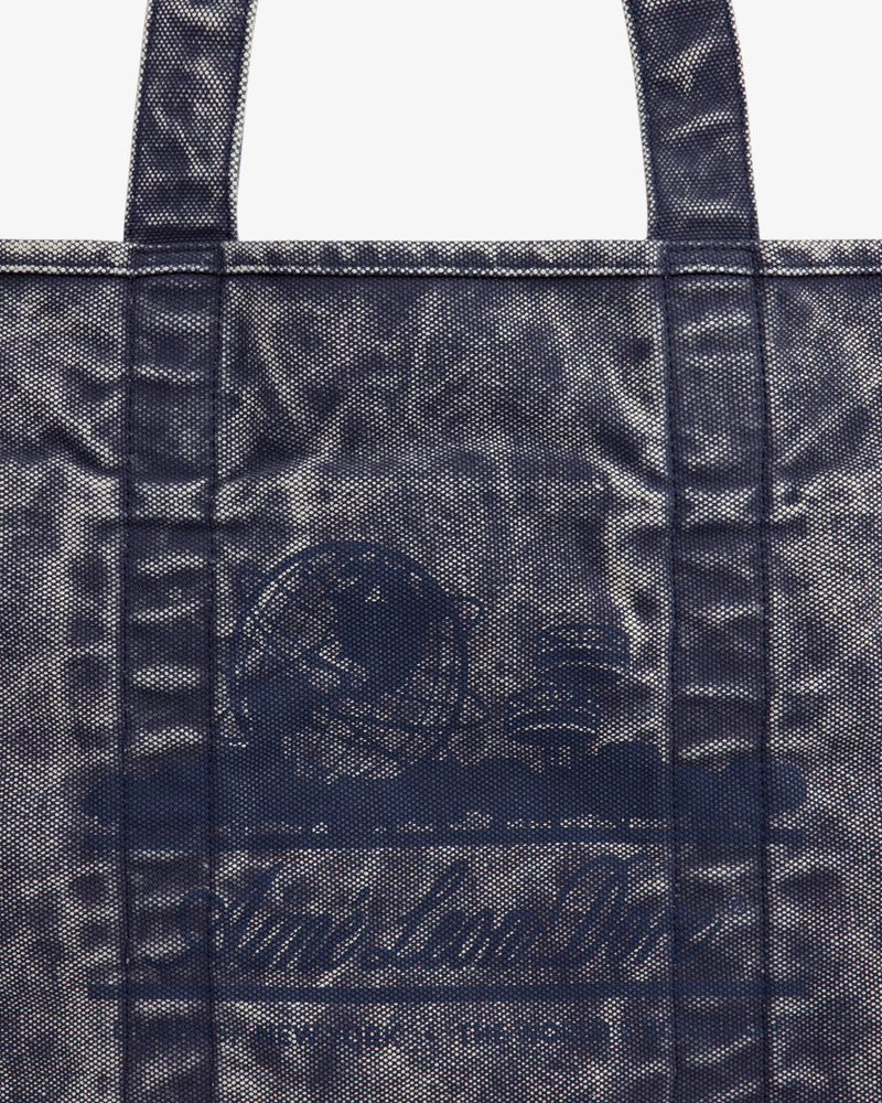 Sun Faded Large Unisphere Tote Bag with blue textured finish, two handles, and faint circular logo on the front.