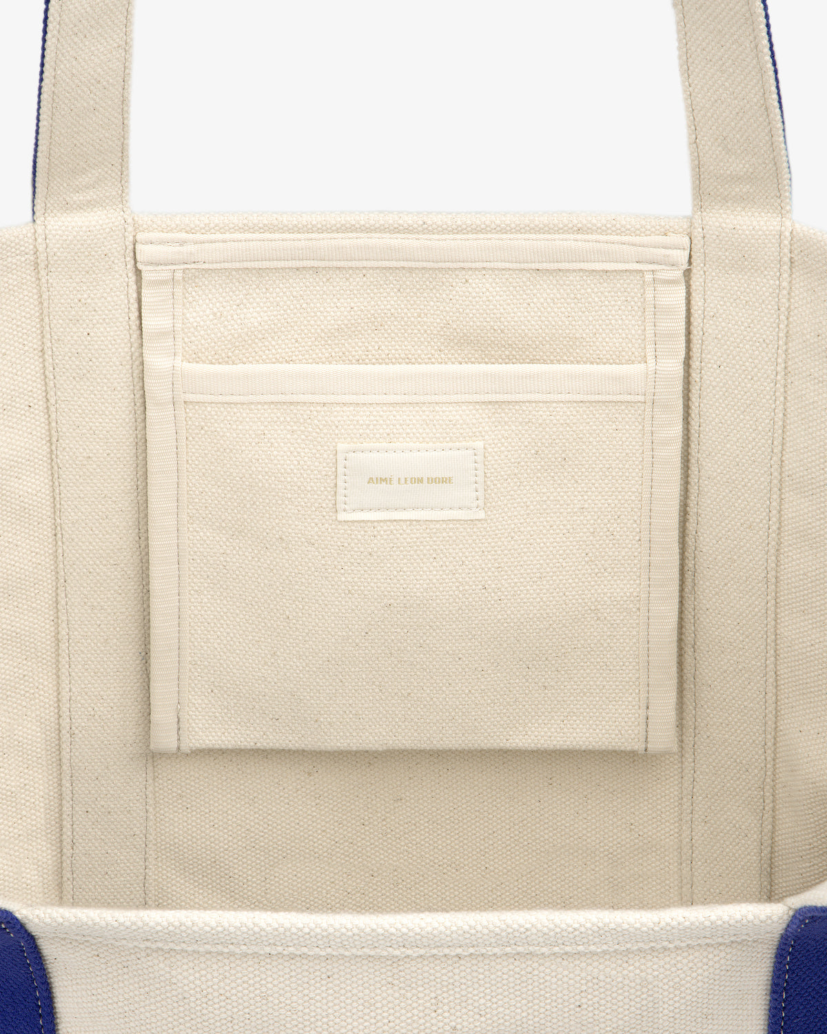 Close-up of the inside of the Krylon Tote Bag, showing a pocket with a small label.