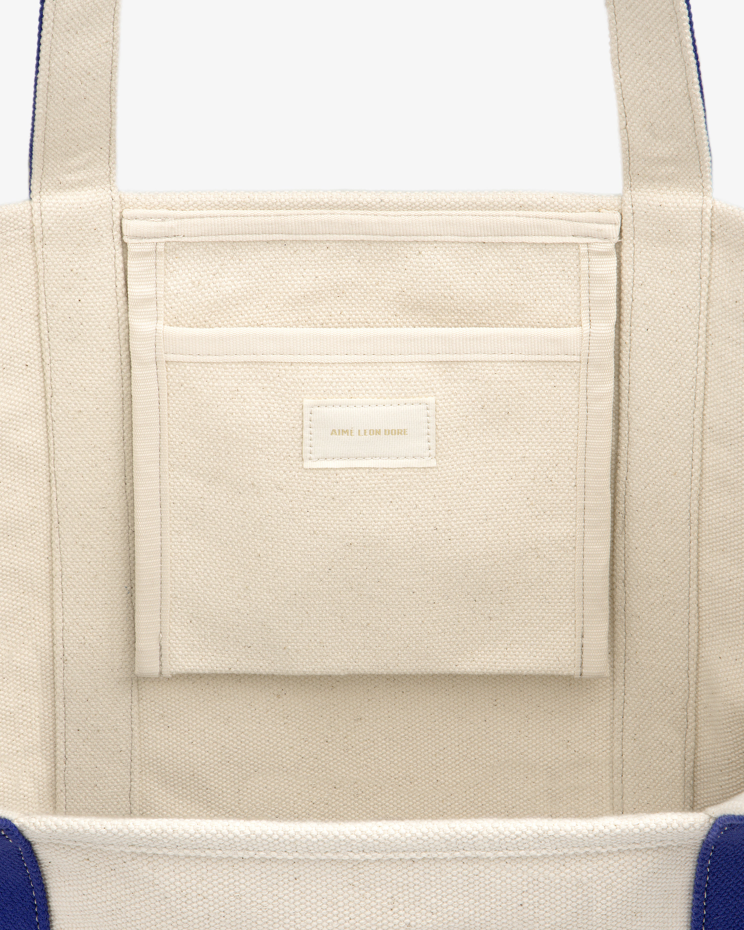 Close-up of the inside of the Krylon Tote Bag, showing a pocket with a small label.